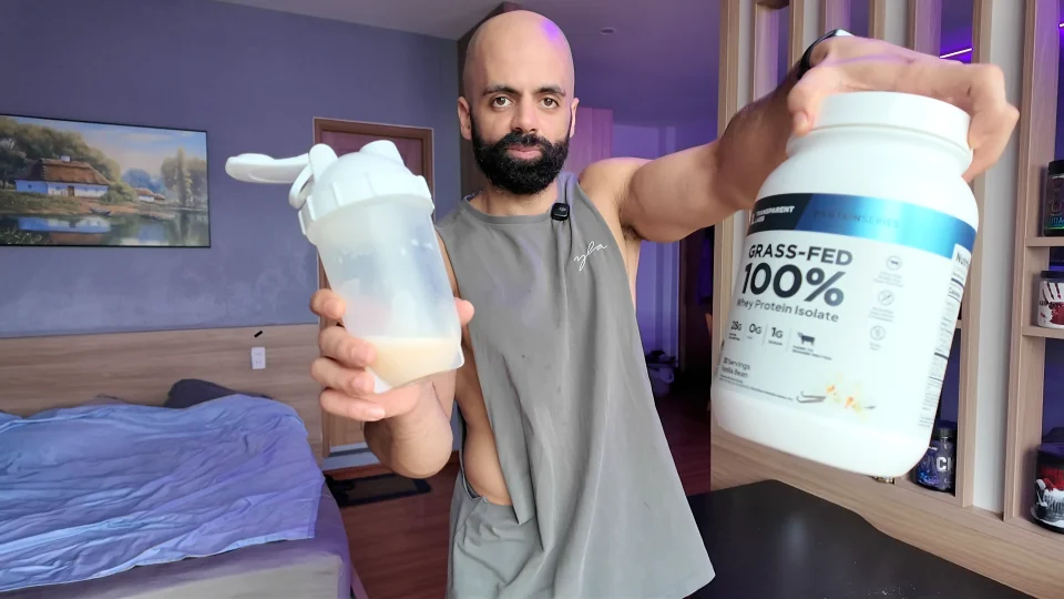 Nader holding Transparent Labs Vanilla Bean whey protein and a mixed shaker