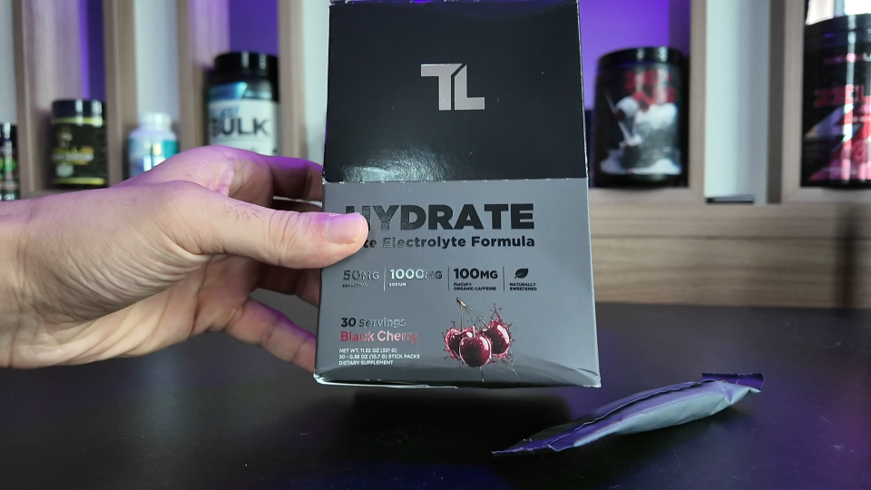 Transparent Labs Hydrate Black Black Cherry box with a stick pack on the table